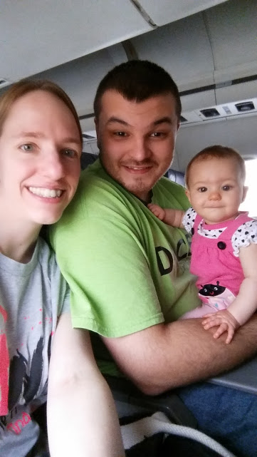 Mommy, daddy, and baby on a plane.