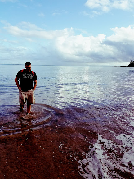 Man walking through water in Oahu, HI