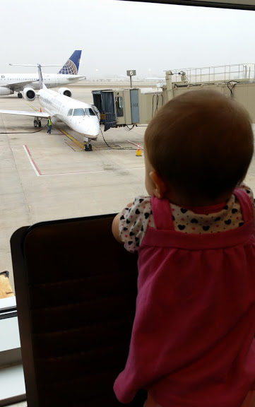 Baby looking at plane